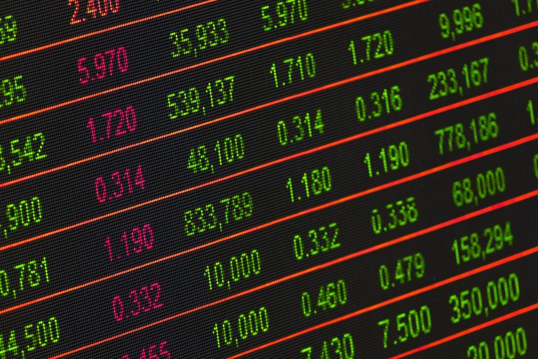 Close-up of a digital stock market data display showing colorful financial numbers and trends
