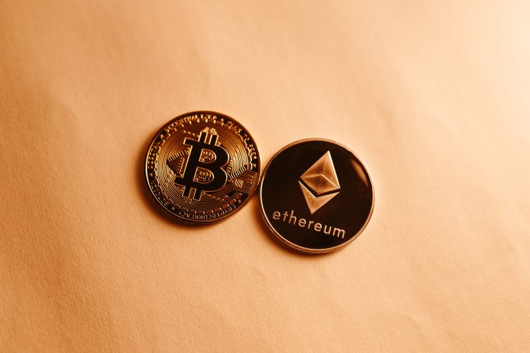 Bitcoin and Ethereum coins depicted on a soft yellow background for cryptocurrency and finance themes